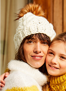 Cable hat with furry pompom